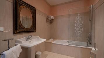 A bathroom with a sink, mirror, bathtub, and shower.