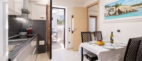 A modern kitchen with a dining area.