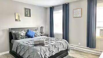 2 habitaciones, escritorio y tabla de planchar con plancha