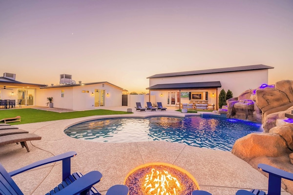 Fire pit crackling next to the mosaic pool as the sun sets