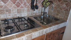 Fridge, stovetop, coffee/tea maker, cookware/dishes/utensils