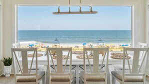 A dining area with a view of the beach and ocean. - Beachfront Luxury Villa in Dewey Beach, Two Master Bedroom (Dewey Beach)