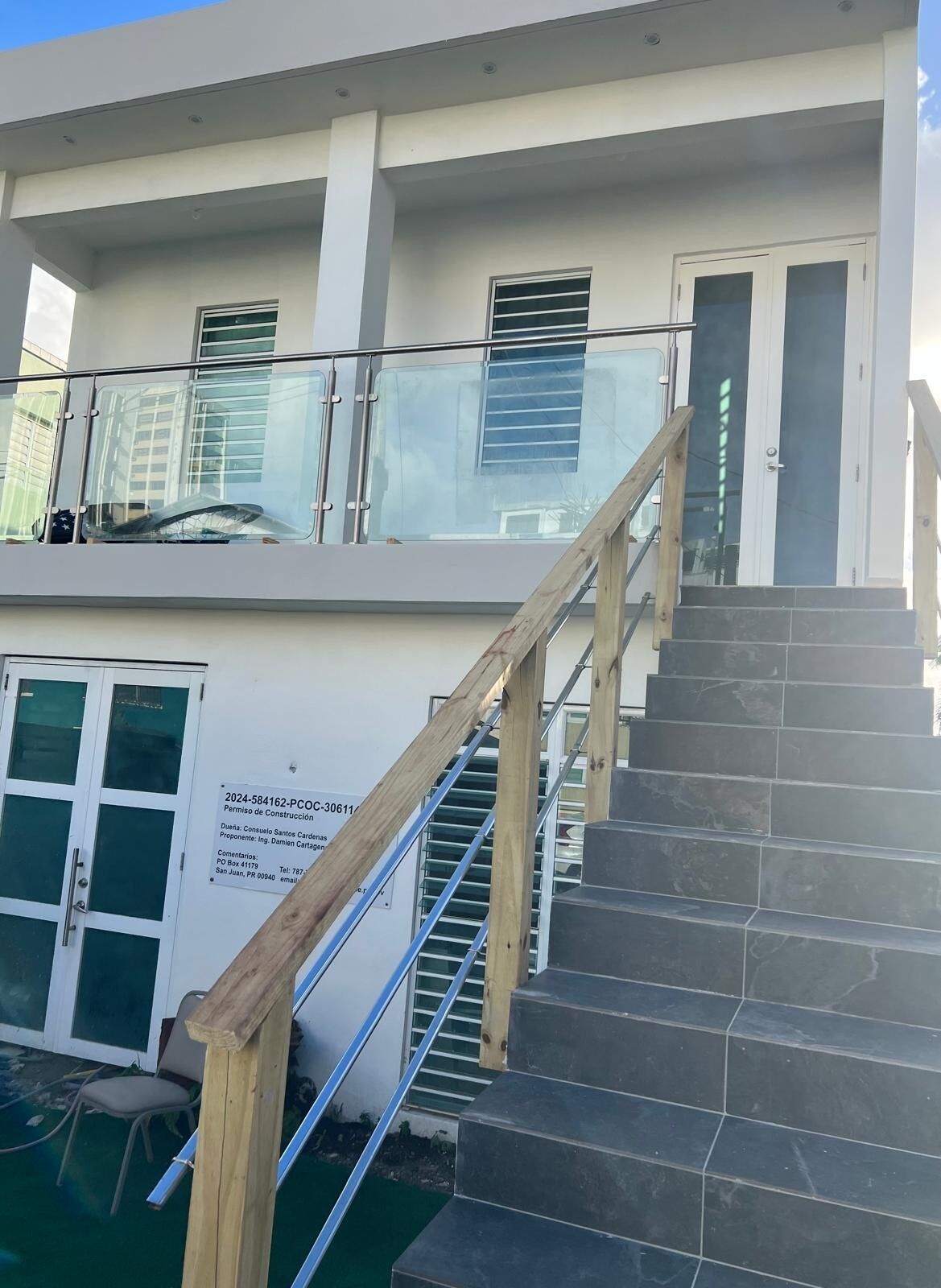 A multi-level building with a staircase and a glass railing.