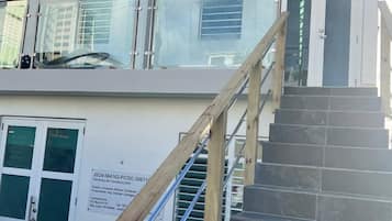 A multi-level building with a staircase and a glass railing.