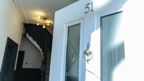 A white door with the number 51, a glass panel, and a doorbell. - The Rockfield By Serene Stays (Anfield)