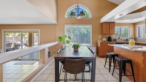 A spacious kitchen with a dining area, a large island, and a view of the outdoors. - Prime Glendale Location 8-Mins From Westgate Entertainment! (Glendale)