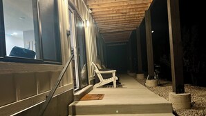 A covered outdoor area with steps leading to a seating area. - Scenic lakeside retreat- 5 minute walk to Palisade State Park and Golf Course (Sterling)