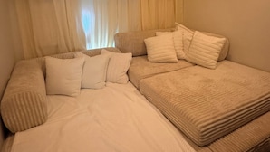 A cozy bedroom with a large bed, a window with sheer curtains, and a soft beige color scheme. - Miami Wellness Sanctuary w/ Sauna, Cold Plunge & Hot Tub (Miami)