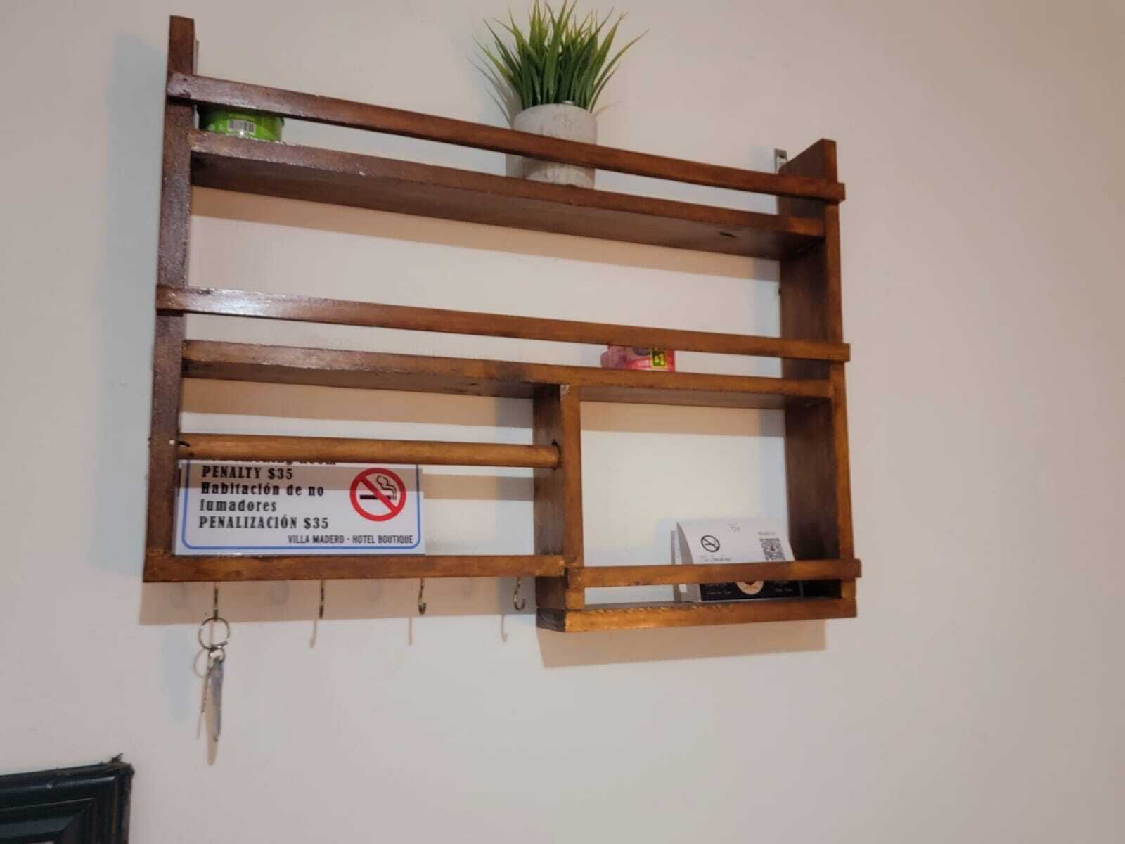 A wooden shelf with a sign indicating a penalty for smoking.