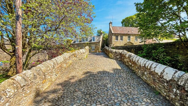 A cobblestone pathway leading to a stone building with a tiled roof. - The Old Baron's Courthouse (Ceres, near St Andrews)