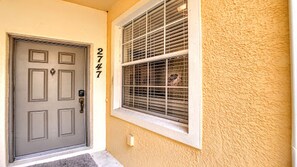 A front door with a number "2747" on the wall beside it. - Disney 3BR Home, Pool, Lake View (Kissimmee)