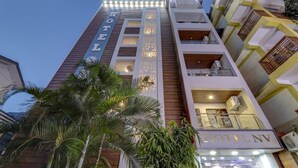 A hotel with a vertical sign reading "HOTEL" and "HOTEL NV" on the facade. - Treebo Trend Hotel NV (Narendranagar)