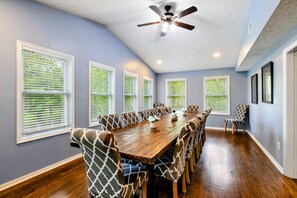 A conference room with a long table, chairs, and a ceiling fan. - Lakefront Retreat, Pool, Boat Dock, Hot Tub (Bumpass)
