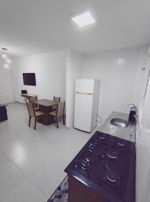Fridge, stovetop, cookware/dishes/utensils, dining tables - 2 Bedroom Condominium House - 350 meters from the Beach (Vila Balnearia Praia Grande)