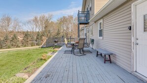 A deck with outdoor furniture, a barbecue grill, and a view of a wooded area. - Poconos Group Getaway w/ Game Room + Fire Pit! (Covington Township)