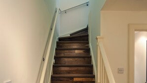 A staircase with wooden steps and a handrail, leading to a door. - Entire Family Apartment- Edinburgh (Edinburgh)