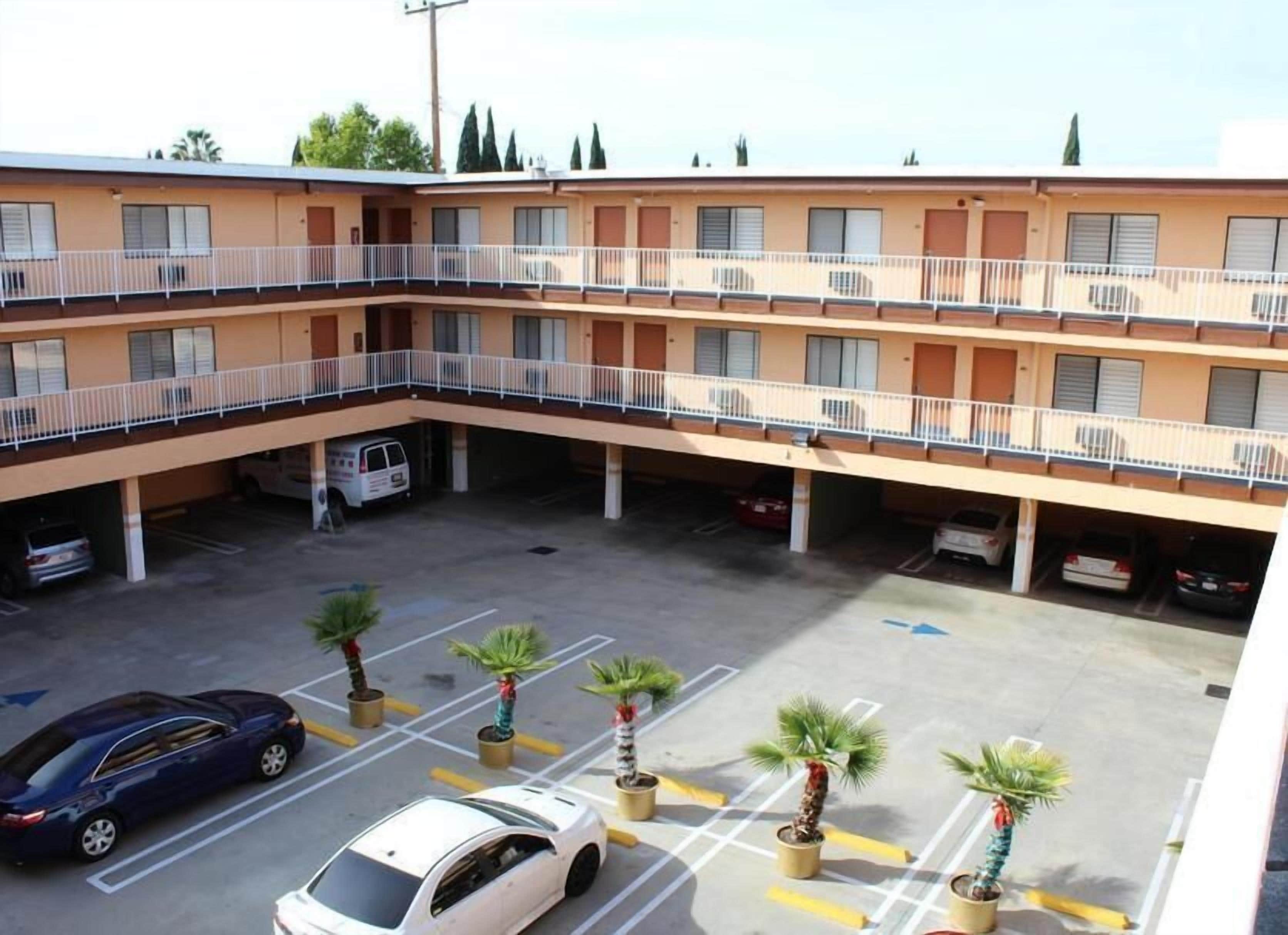 A multi-story parking garage with several cars parked.