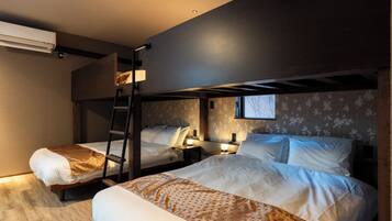 A room with two beds, a ladder, a window, and a wall-mounted air conditioner.
