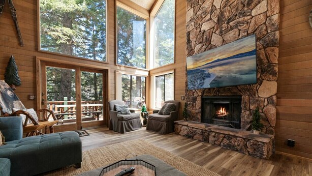 A spacious living room with a stone fireplace, large windows, and a cozy seating area. - The Circle Moon - 1 mi to Bear Mtn/ Game Room+Spa! (Big Bear Lake)