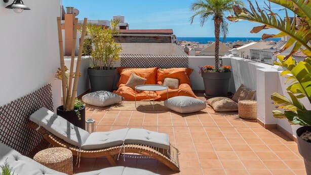 A rooftop terrace with a sofa set, a small table, and lounge chairs. - Main street free parking 5 minutes away (Nerja)
