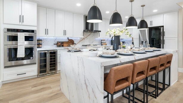 A modern kitchen with white cabinets, stainless steel appliances, a marble island, and pendant lighting. - 8BR/5BA Mini Resort w/4 En-Suites, HEATED Pool, Hot Tub,Billiards & Arcades (Glendale)