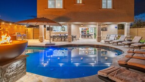 A modern outdoor pool area with a fire feature, lounge chairs, and a bar area. - 8BR/5BA Mini Resort w/4 En-Suites, HEATED Pool, Hot Tub,Billiards & Arcades (Glendale)