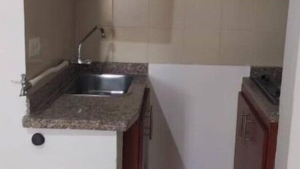 A compact kitchen with a sink, countertop, and cabinets. - Colorful awakening! apartment-studio (Cali)
