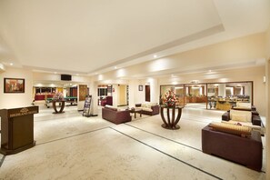 En rummelig lobby med reception, siddepladser og spiseområde.