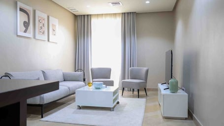 Family Apartment, City View | Living area | Flat-screen TV