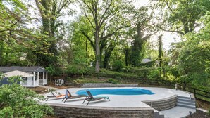 A backyard with a swimming pool, a covered patio, and a small shed. - Hilltop Retreat w/ Pool, Games & Sunroom (Woodlawn)