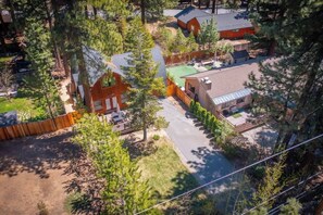 A residential area with houses, a driveway, and a fenced yard. - The Canoe Cabin (Incline Village)