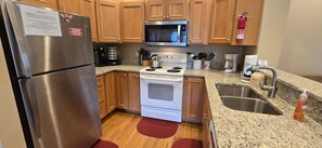 Efficient kitchen with appliances, sink, and ample storage.