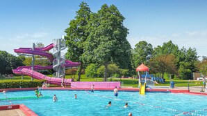 A swimming pool with multiple slides and a playground area. - Beautiful home in Heinkenszand (Heinkenszand)