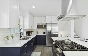 Enjoy cooking in this well-equipped kitchen with a stainless steel range, gas stove, and appliances.
