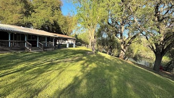 Escape to a serene natural oasis with a peaceful pavilion surrounded by mature trees.