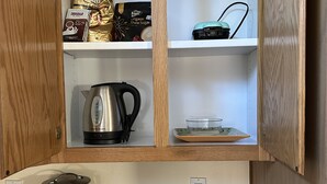 A kitchen with wooden cabinets, a coffee maker, a kettle, a toaster, and a T-fal air fryer on the counter. - 3BR Farmhouse Getaway, Group-Friendly, WiFi, AC, Trails (Warner Springs)