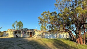 A two-story house with a front porch and a garage. - 3BR Farmhouse Getaway, Group-Friendly, WiFi, AC, Trails (Warner Springs)