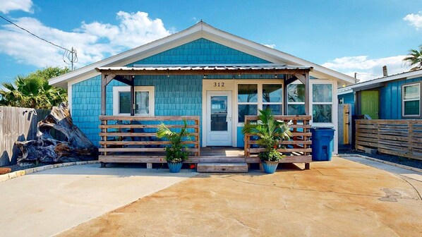 A small, single-story building with a blue exterior and a white door marked with the number 312. - Pet Friendly, Old Town Location, Golf Cart Access, Close to the Beach (Port Aransas)