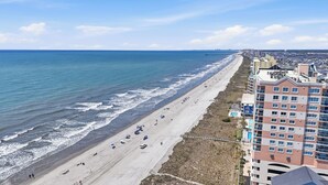 A coastal hotel with a beach view, multiple floors, and a swimming pool. - Beautiful Ocean Front Condo - Cherry Grove (North Myrtle Beach)