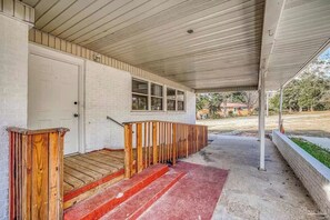Step up to comfort on this inviting porch with a cozy landing area and a warm welcome mat.