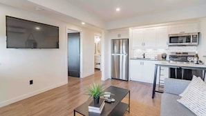 A modern apartment with a living room, kitchen, and dining area. - INN ON THE BENCH (Lincoln)