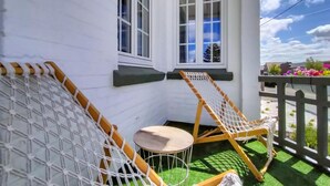 A corner of a room with a white wall, a window, and a small round table. - 5 bedroom beautiful home in Westende (Westende)
