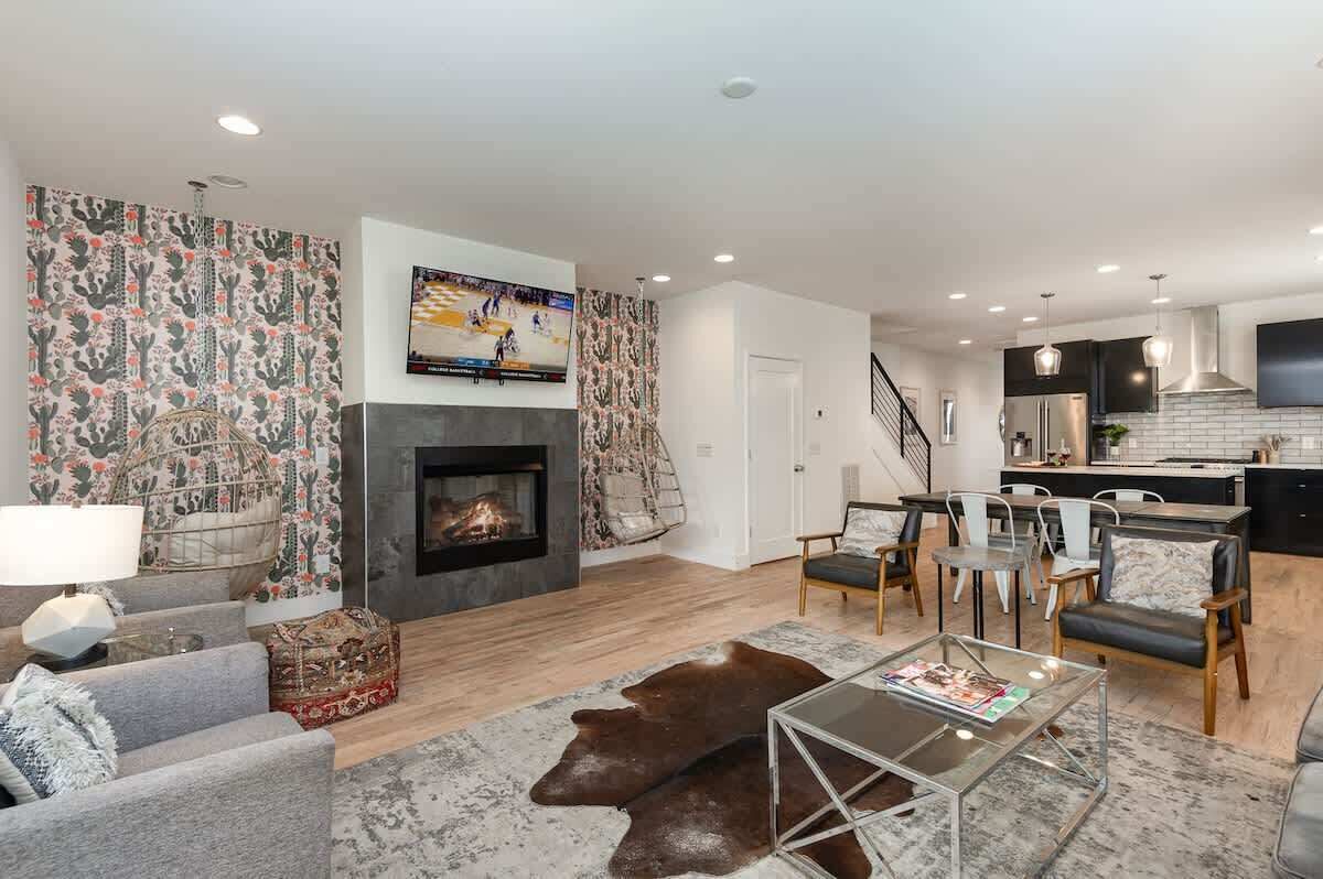 Open-concept living area with cozy furnishings, a Smart TV, and a fireplace.