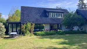 A modern house with a dark tiled roof, large windows, and a well-maintained lawn. - 3 bedroom nice home in Birkerød (Birkerød)