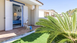 A modern house with an open door leading to a room with a bed and a chair. - Le Rêve by Interhome (Valledoria)