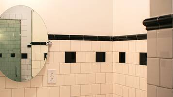 A bathroom with a sink, toilet, and mirror.