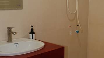 Standaard eenpersoonskamer | Badkamer | Een douche, een haardroger, pantoffels, zeep