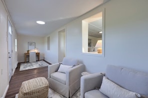 A modern living room with a sofa, armchairs, a small table, and a mirror on the wall. - Homestead Haven | Fire Pit, Pickleball & Fun (Gettysburg)
