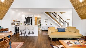 A spacious loft with a kitchen, dining area, and living room. - Modern A-Frame Away from it All! (Marshall)