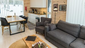 A cozy cabin interior with a dining area, kitchen, and seating space.